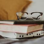 Glasses on top of books